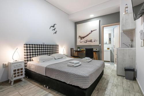 a bedroom with a large bed and a bathroom at Comfort Stay Athens Airport Hotel - FREE shuttle from and to the airport in Spáta