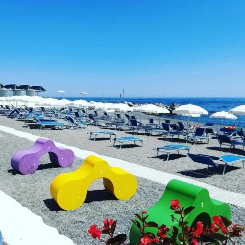 a beach with some chairs and somespectacular at Villa Quadrifoglio in Arenzano