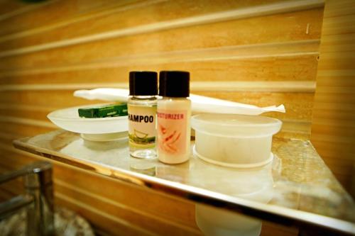 two bottles of essential oils sitting on a shelf in a sauna at Creek Forest - Riverside Boutique Resort in Rishīkesh