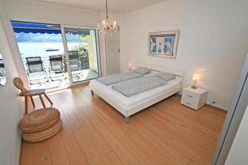 a bedroom with a bed and a view of the ocean at Villa Genovese al Lago in Minusio