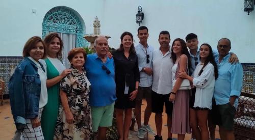 a group of people posing for a picture in front of a mosque at HOSTAL LA CRUZ 1872 in Chipiona
