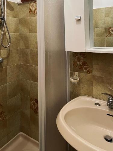 a bathroom with a sink and a shower at Climbing House Chèrie Madeleine in Lido Di Fondi