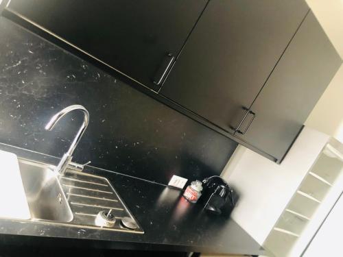 a kitchen counter with a sink and a faucet at Apartment am Ponyhof in Sankt Kanzian