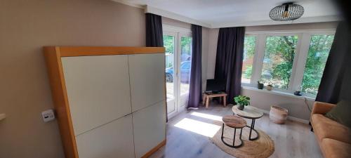 una sala de estar con un gran armario blanco y un sofá en Chalet Op Bosrijk Familiepark, en Raalte