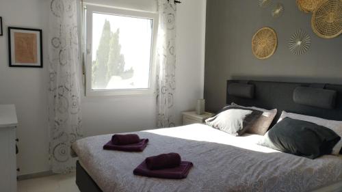 a bedroom with a bed with two towels on it at Casa Patricia, Ladera del Mar, Nerja in Nerja