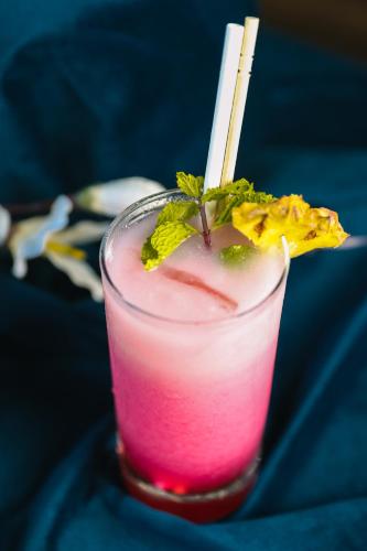 a drink with a pink drink with a white straw at Enrise by Sayaji, Khed Shivapur Pune in Pune