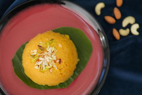 a red plate with a bowl of food with nuts at Enrise by Sayaji, Khed Shivapur Pune in Pune