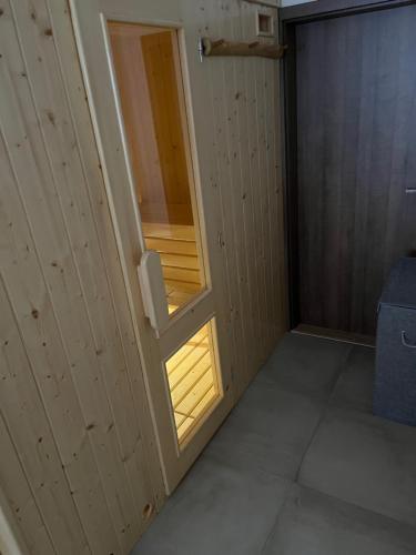 a small room with a door with a window at Bezručova škola in Staré Hamry