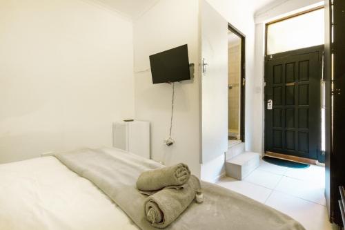 a bedroom with a bed with a towel on it at Linden Guest House in Johannesburg