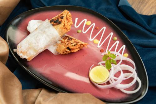 a plate of food with a tortilla and a drink at Enrise by Sayaji, Khed Shivapur Pune in Pune