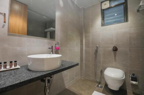 a bathroom with a sink and a toilet at Enrise by Sayaji, Khed Shivapur Pune in Pune