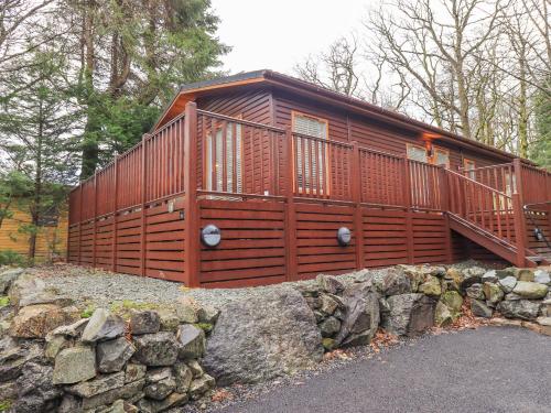 a large wooden cabin on a stone wall at 25 Thirlmere in Windermere