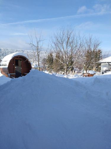 a pile of snow in front of a house at Apartamenty Równia 2 in Ustrzyki Dolne
