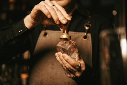 a woman holding a bottle in her hands at The Lamp Hotel & Spa in Norrköping