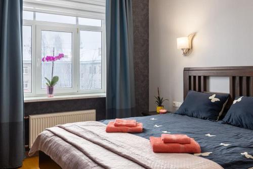 a bedroom with a bed with two towels on it at Lovely 2-bdrm condo ideal for couples and family with children, free parking on premises in Rīga