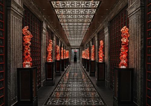 a hallway in a building with red flowers on the floor at Four Seasons Hotel Beijing in Beijing