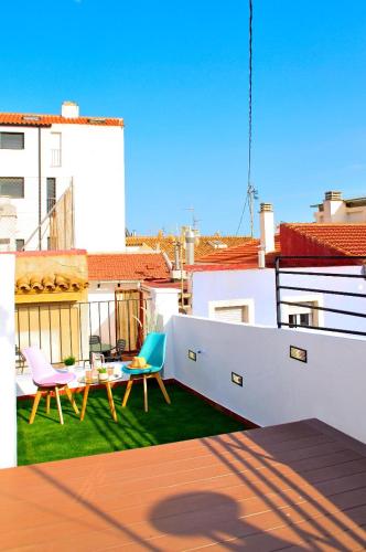 a balcony with a table and chairs on a roof at ABAL Apartments - Barrio in Alicante