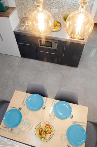 a table with blue plates on it in a kitchen at ABAL Apartments - Barrio in Alicante