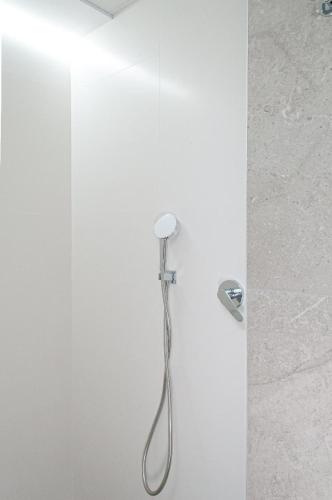 a shower with a shower head in a bathroom at ABAL Apartments - Barrio in Alicante