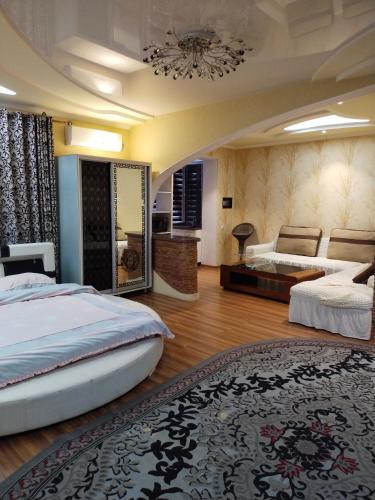 a large bedroom with two beds and a mirror at Мтко-1 in Khujand