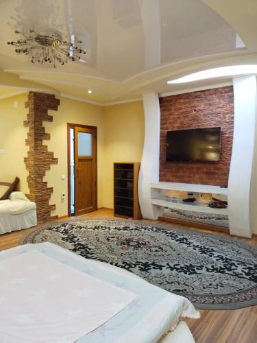 a bedroom with a bed and a tv on a wall at Мтко-1 in Khujand