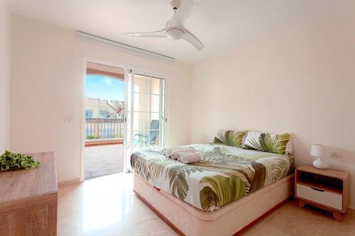 a living room with a bed and a balcony at luxury duplex apartment with beautiful sea views in Palm-mar