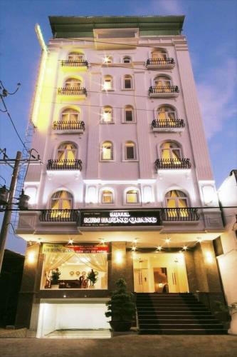 a tall white building with balconies and stairs on it at Kim Huong Quang Hotel in Phu Quoc
