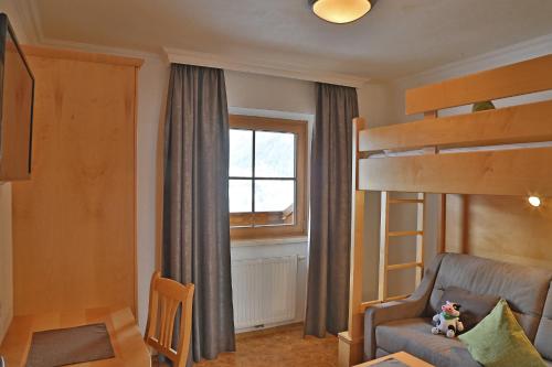 a small room with a bunk bed and a chair at Ferien Bauernhof Maurachhof in Sankt Johann im Pongau