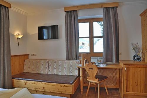 a bedroom with a desk and a table with a chair at Ferien Bauernhof Maurachhof in Sankt Johann im Pongau