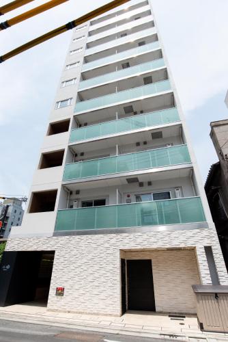 an apartment building on the corner of a street at Dash Living Tsukiji in Tokyo