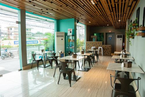 une salle à manger avec des tables et des chaises dans un restaurant dans l'établissement Felicity Island Hotel, à Mactan