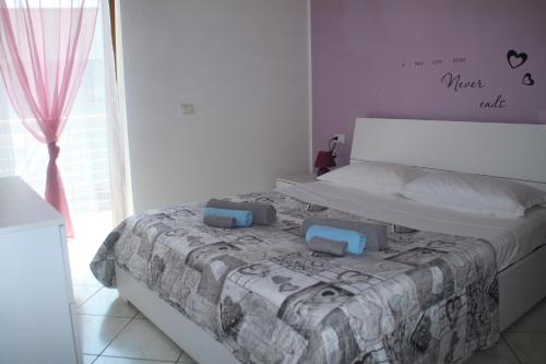 a bedroom with a bed with two pillows on it at Casa Vela in Riva del Garda