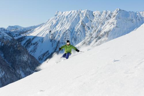 a man is skiing down a snow covered mountain at NOVA Moments Boutique Hotel in Pertisau