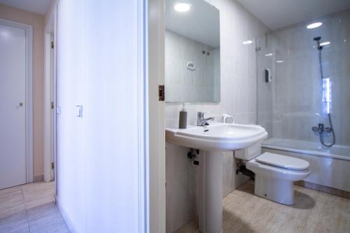 a white bathroom with a sink and a toilet at ESPACIO 5 - Primera Línea de Playa in Cullera