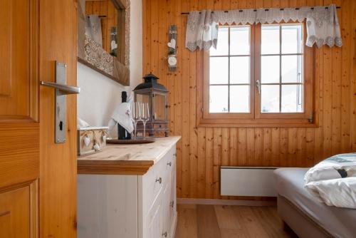 a kitchen with a sink and a window in a room at Chalet Bijou in Blitzingen