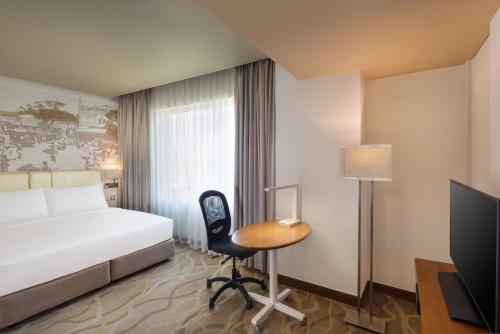 a hotel room with a bed and a desk and a chair at Radisson Hotel Colombo in Colombo
