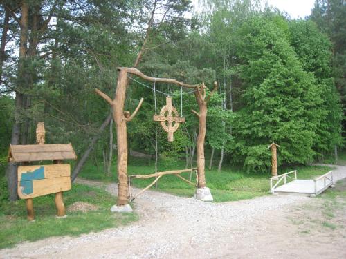 a park with a swing and a tree with a playground at Poilsio ir sveikatinimo sodyba Pušų Šlamesy in Vilnius