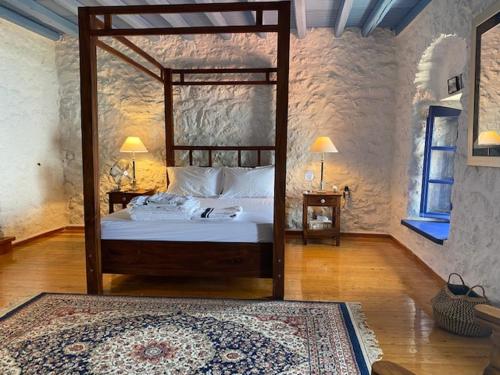 a bedroom with a large canopy bed in a room at The Villa of Blues in Kalamata