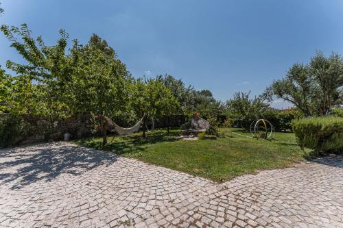 a backyard with a hammock in the grass at GuestReady - Seven Farm in Mangualde