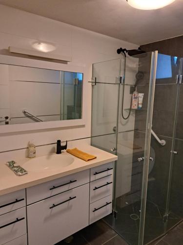 a bathroom with a sink and a shower at Pura vida in Ashkelon