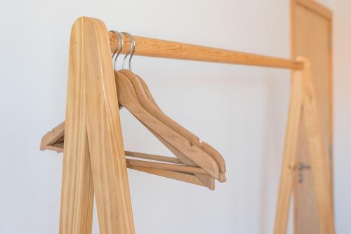 a pair of wooden hangers in a closet at Contemporary countryside haven in Mangualde in Mangualde