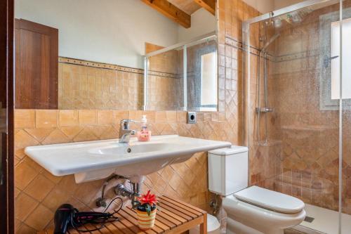a bathroom with a sink and a toilet and a shower at Can Jaume in Pollença
