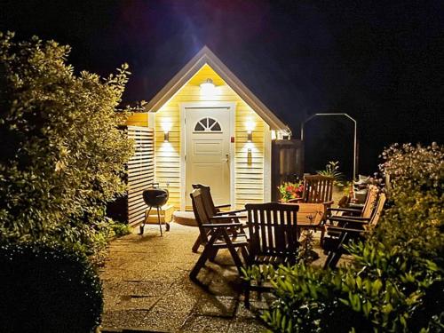 a house with a white door and chairs and a patio at 4 person holiday home in FÄRLÖV-By Traum in Färlöv