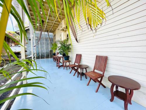 a row of chairs and tables on a patio at U're Holitel in Haad Rin