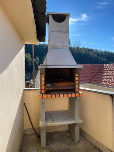 an outdoor oven on a balcony with a view at Aroucanatur, Casa de Montanha in Arouca