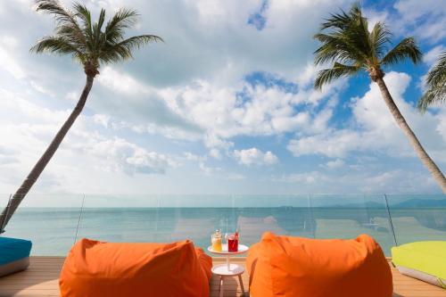 a view of the ocean from a resort with palm trees at Sea&Sky Beach Resort in Mae Nam