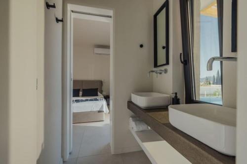 a bathroom with a tub and a sink and a bed at Villa Dimi private pool, sea view & 3 bedrooms in Paleros