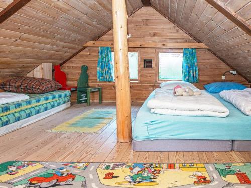 a room with two beds in a wooden house at 8 person holiday home in Hovborg-By Traum in Hovborg