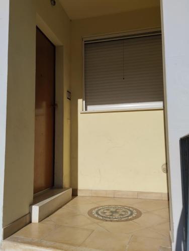 a room with a door and a window with a rug at 37 Nodi in Ancona