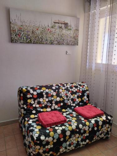 a couch with two pillows on it in a room at 37 Nodi in Ancona